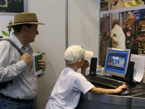 A father and son playing with Ollie at the NSW Farmers Federation stand at the Royal Easter Show